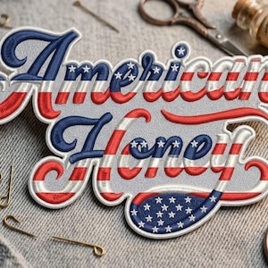 May include: Embroidered patch with the words "American Honey" in a patriotic design. The text is in red, white, and blue, with a star-spangled banner theme. The patch is on a denim background, with sewing tools.