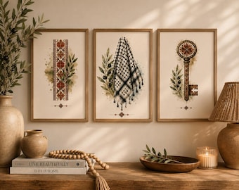 May include: A set of three framed wall art prints featuring a vertical red floral pattern, a black and white checkered keffiyeh draped over olive branches, and an ornate key with a circular top, all displayed on a light-colored wall surface.