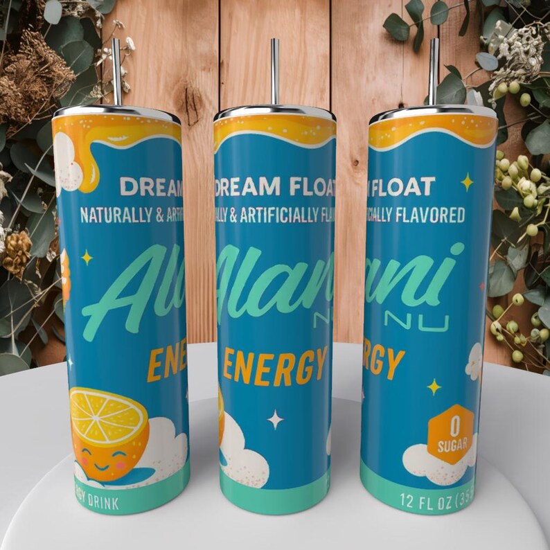 May include: Three teal Alani Nu Energy drink tumblers with silver straws. The tumblers have a yellow and orange top, with the words "DREAM FLOAT" and "Alani Nu ENERGY" printed on them. A smiling lemon graphic is also visible.