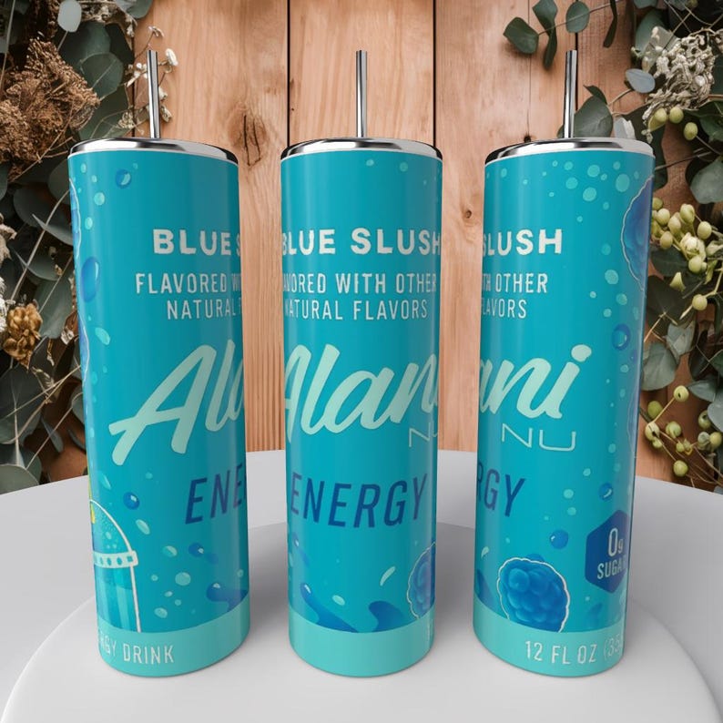 May include: Three turquoise insulated tumblers with silver lids and straws. Each tumbler features the text "BLUE SLUSH" and "Alani Nu ENERGY" in white script. The design includes water droplets and a berry graphic. Each tumbler holds 12 fl oz.