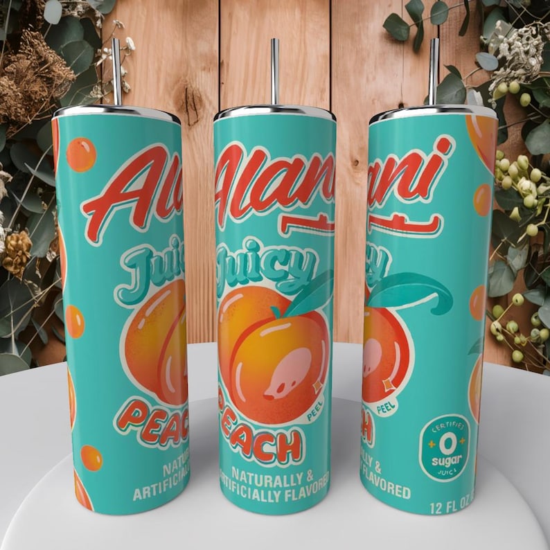 May include: Three turquoise tumblers with silver straws feature a peach design. The tumblers have the words "Allan ni Juicy Peach" in orange and white script. The design includes peach illustrations and the text "Naturally & Artificially Flavored". Each tumbler is 12 fl oz.