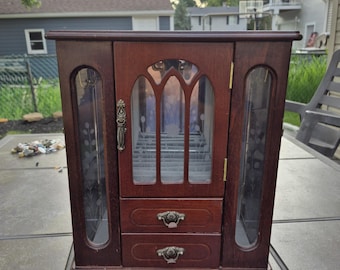 Small vintage wood jewelry box three doors and two drawers for storage measures 13 inches high and 10 in wide brown color