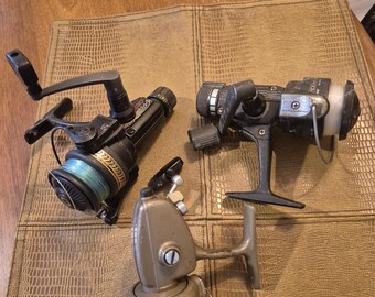 3 freshwater spinning reels the first is a Daiwa7250 hrla the second is the Zebco Pro Staff 20 and a third is a zip code 608 all three are i