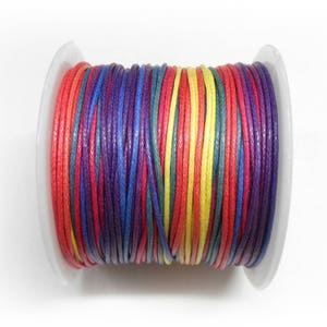 May include: A spool of colorful waxed cotton cord in red, yellow, green, blue, and purple.
