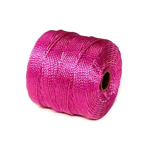 May include: A spool of bright pink embroidery floss.