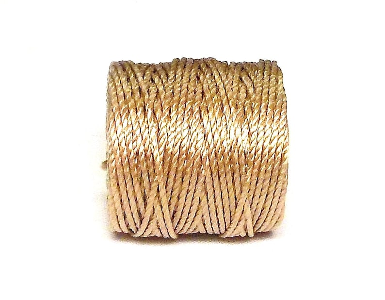 May include: A spool of beige embroidery floss.