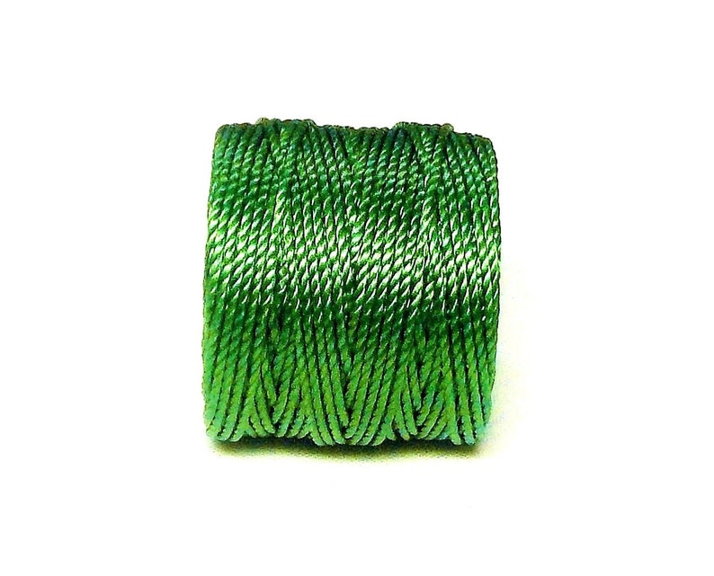 May include: A spool of green embroidery floss.