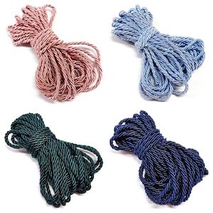 May include: Four spools of twisted cord in different colors: pink, light blue, dark blue, and dark green.