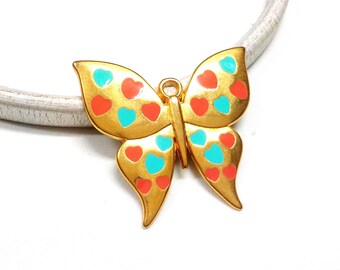 Puede incluir: Encanto de mariposa de tono dorado con corazones de esmalte rojo y turquesa.