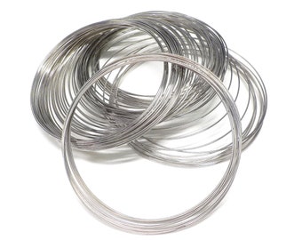 May include: A pile of silver-colored wire rings, likely for jewelry making or crafting.