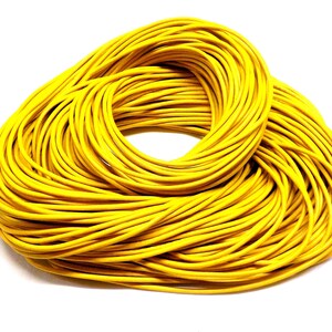 Puede incluir: Una bobina grande de cordón amarillo brillante. El cordón está enrollado apretado y listo para ser usado para manualidades u otros proyectos.