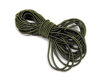 May include: A spool of green elastic cord with a black stripe running along the length of the cord.