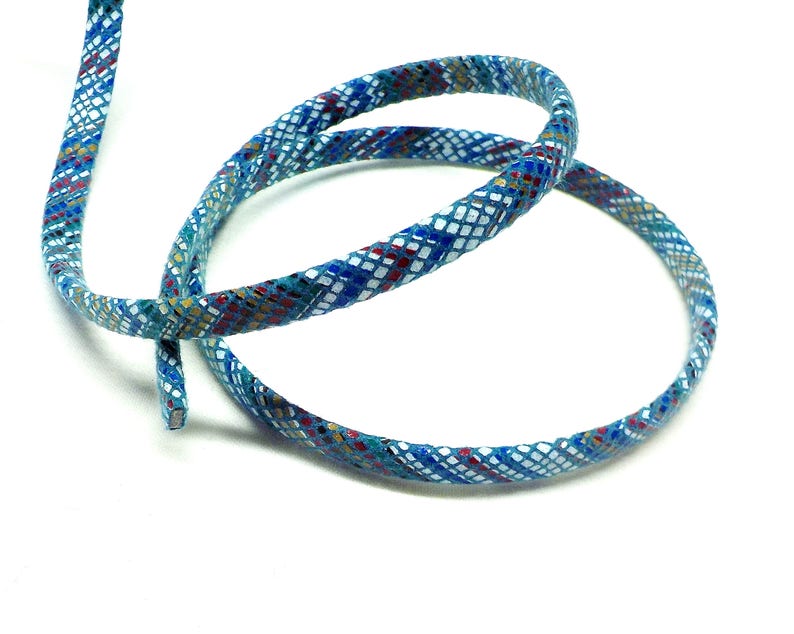 May include: A blue and white patterned trim with a woven texture. The trim has a geometric design with red, gold, and green accents.