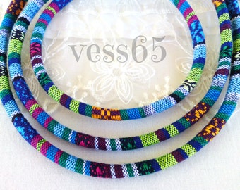 May include: Three colorful braided cords in blue, green, purple, pink, white, and orange. The cords are woven together in a striped pattern.