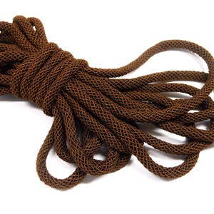 May include: A coil of brown braided cord, made of a woven mesh material.