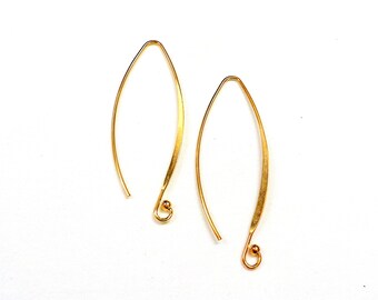 May include: A pair of gold-toned earrings with a simple, curved design. The earrings are made of thin wire and have a small ball at the end.
