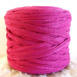 May include: A large spool of deep pink t-shirt yarn. The yarn is made from recycled t-shirts and is perfect for crocheting or knitting.