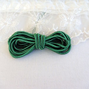 May include: A roll of green elastic cord, perfect for sewing projects or crafts.