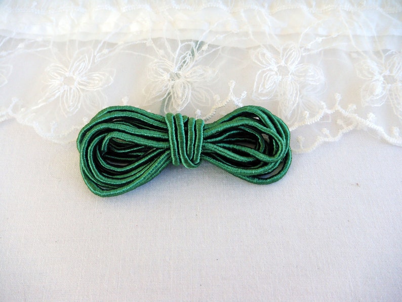 May include: A roll of green elastic cord, perfect for sewing projects or crafts.