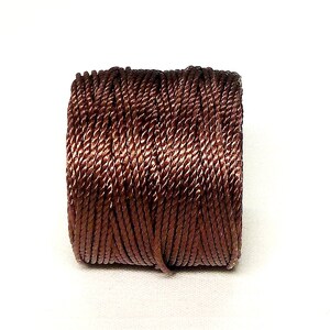 May include: A spool of brown twisted cord.