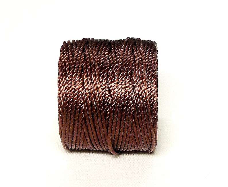 May include: A spool of brown twisted cord.