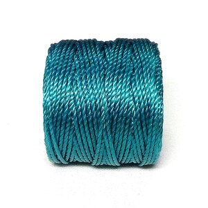 May include: A spool of teal blue embroidery floss.