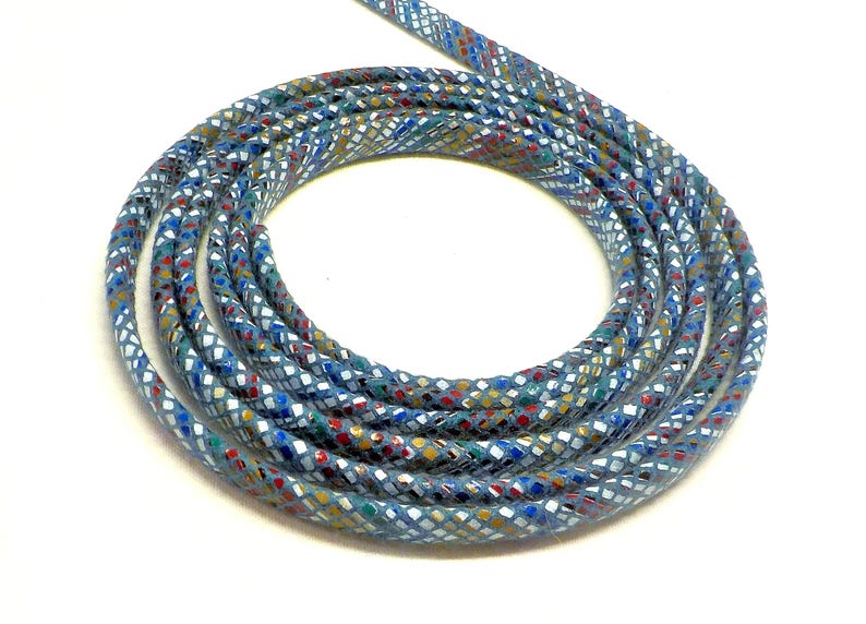 May include: A close-up of a blue cord with a multi-colored geometric pattern. The cord is coiled into a circle.
