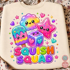 Op de afbeelding: Een cr&egrave;mekleurig sweatshirt met ronde hals en een kleurrijke grafische print van een lachende regenboogwolk, een roze ster, een ijsje en een kubus met hartjes. De tekst SQUISH SQUAD staat in grote, veelkleurige bubbelletters onder de iconen.