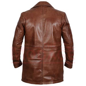May include: A brown leather jacket with a long cut and a collar. The jacket has a single breasted closure and two pockets on the front.