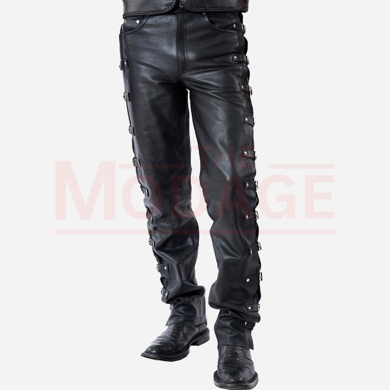 May include: Black leather trousers with multiple buckles and straps down the sides of the legs.