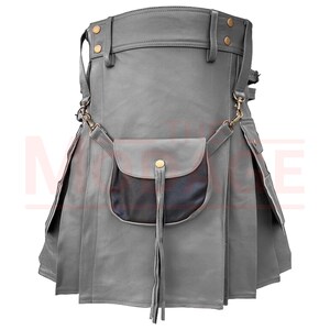 May include: A gray leather kilt with a flap pocket and a fringe detail. The kilt has a belt with buckles and straps.