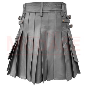 May include: A gray leather kilt with pleats and side pockets. The kilt has a buckle closure and adjustable straps.