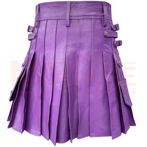 May include: A purple leather kilt with pleats and pockets. The kilt has a buckle closure and is made of genuine leather.