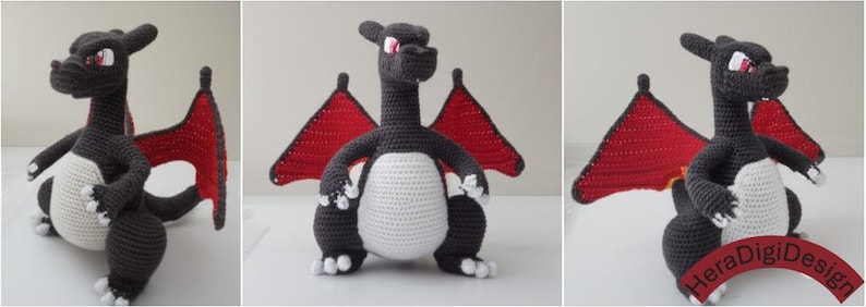 May include: Crocheted dragon toy in shades of gray, white, and red. The dragon has a long neck, large red wings, and a white belly. The toy is handmade and appears to be a character from a popular franchise.
