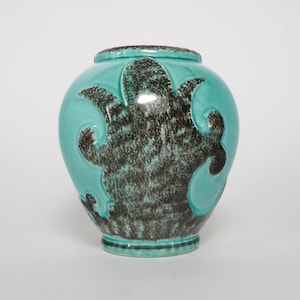 May include: A set of three ceramic mugs with a speckled, cream-colored glaze. Each mug features a different hand-painted floral design in shades of blue, green, and yellow. The mugs have a simple, modern shape.