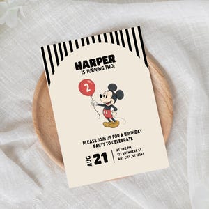 May include: A birthday invitation featuring Mickey Mouse holding a red balloon with the number 2. The invitation has the text "HARPER IS TURNING TWO!" and details for the party, including the date, time, and address. The invitation is on a wooden plate.