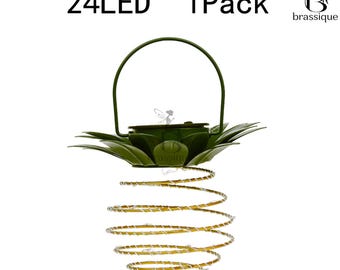 May include: A hanging solar light featuring a green metal top shaped like leaves with a handle and a spiral gold wire body containing 24 LED lights. The text 24LED and 1Pack appears above the object, with a logo in the top right corner.