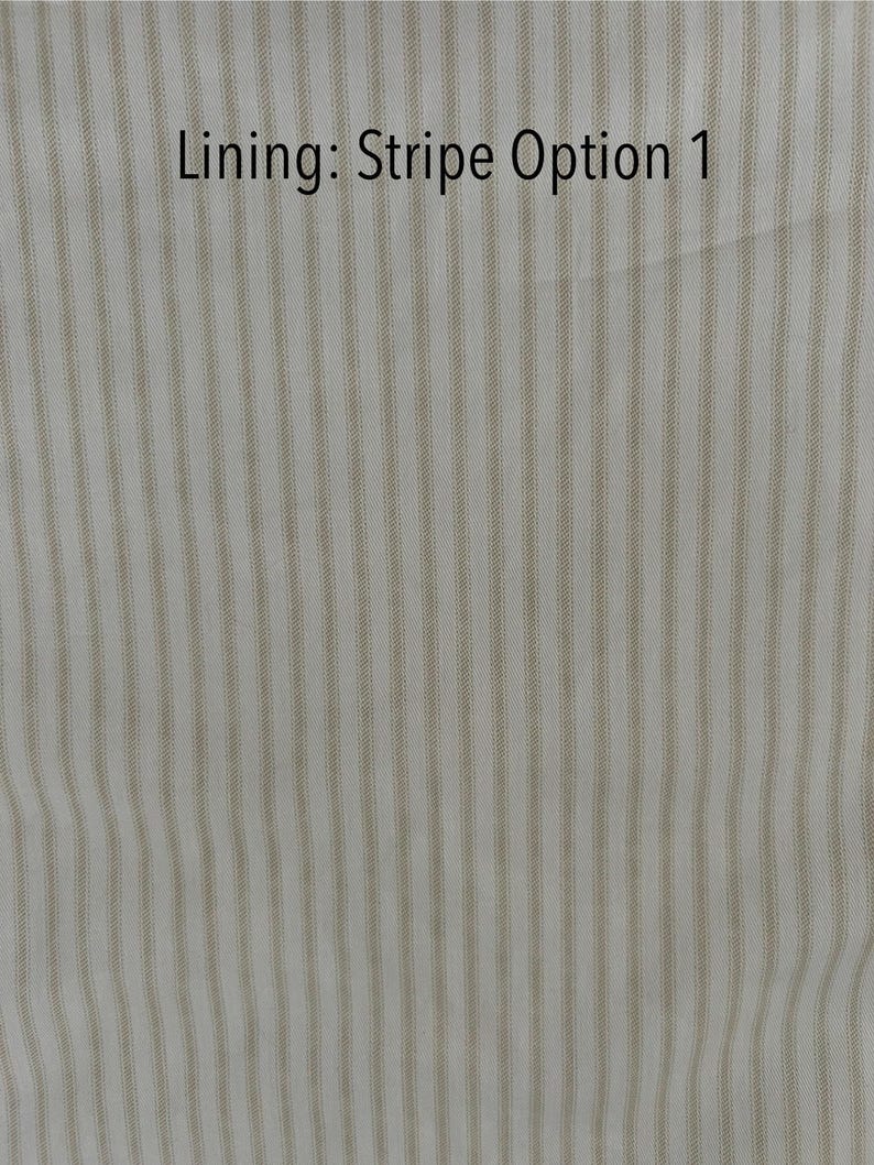 May include: Close-up of a fabric with vertical stripes in beige and white. The text "Lining: Stripe Option 1" is displayed in black at the top of the image. The fabric has a subtle texture.