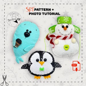 May include: Set of three handmade felt ornaments: a teal seal holding a coffee cup, a black and white penguin, and a snowman with a green hat and scarf. The image includes the text "SET PATTERN + PHOTO TUTORIAL".