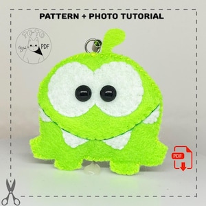 May include: Green felt plush toy with white eyes and teeth, resembling a cartoon character. The toy has a loop for hanging and is labeled "TOTO toys PDF".