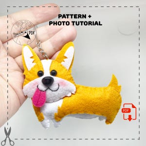 May include: A handmade felt corgi dog keychain with a yellow and white body, black eyes, and a pink tongue. The keychain has a metal ring and the text "PATTERN + PHOTO TUTORIAL".