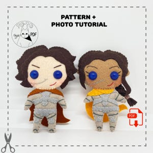 May include: A digital download pattern and photo tutorial for making two felt plushies. The plushies are a brown-haired character with a brown cape and a brown-skinned character with a yellow cape. Both characters have gray armor and blue eyes.