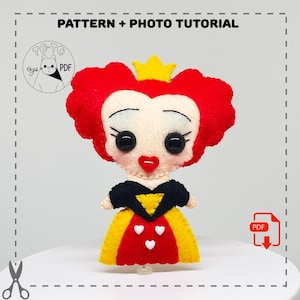 May include: A felt doll of the Queen of Hearts from Alice in Wonderland. She has red hair, a yellow crown, a black and yellow dress, and a red dress with white hearts. The doll is holding a sceptre.