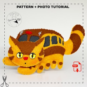 May include: A brown and yellow felt cat plush toy with a bus on its back. The cat has large yellow eyes and a red nose. The bus has brown and grey stripes and windows. The toy is a pattern and photo tutorial for making a similar plush toy.