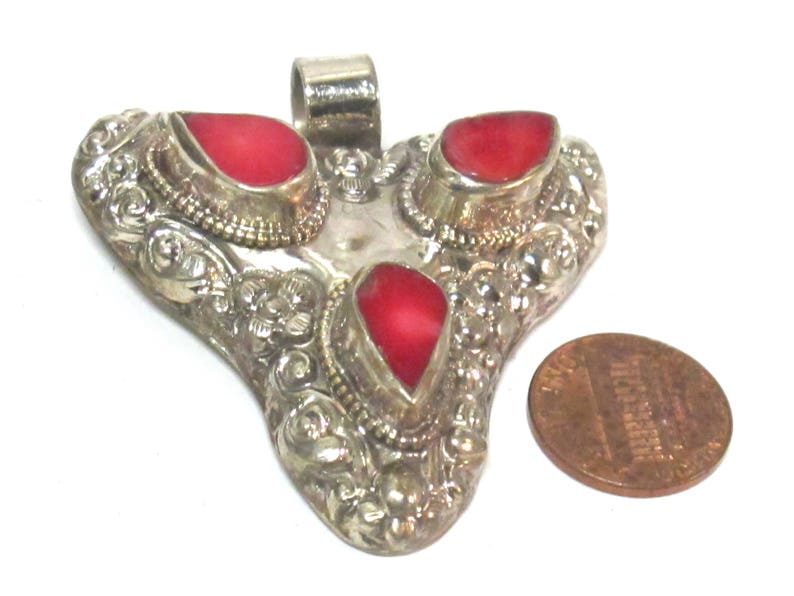 Ethnic Tibetan triangular arrowhead shape coral inlaid pendant from Nepal with lotus flower on reverse side 1 Pendant PM585A