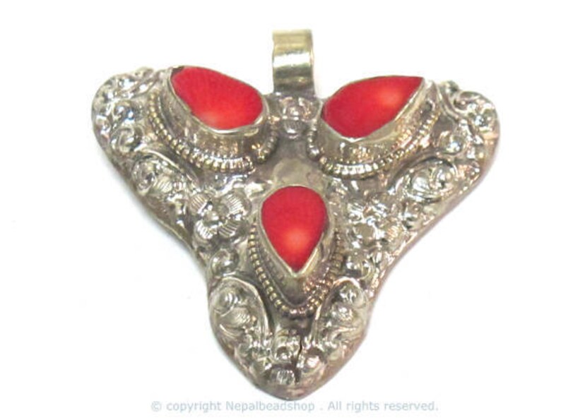 Ethnic Tibetan triangular arrowhead shape coral inlaid pendant from Nepal with lotus flower on reverse side 1 Pendant PM585A