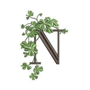 May include: Embroidered letter N with a leafy green clover design. The letter is brown and the clover is green.