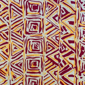 May include: A fabric with a geometric pattern in shades of burgundy and gold. The pattern features triangles and squares.