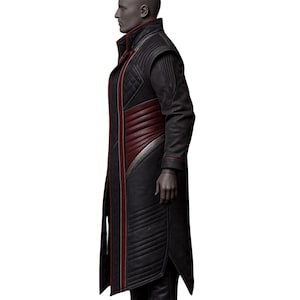 May include: A long black coat with red and silver accents. The coat features a high collar, quilted shoulders, and a diagonal red panel across the chest. The coat has a tailored fit and a split hem.