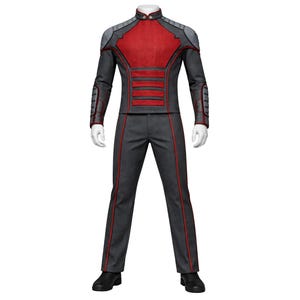 May include: A futuristic-style outfit in gray, red, and black. The jacket has a high collar and red accents, with gray shoulder and arm details. The pants are gray with red side stripes. Black shoes complete the look.